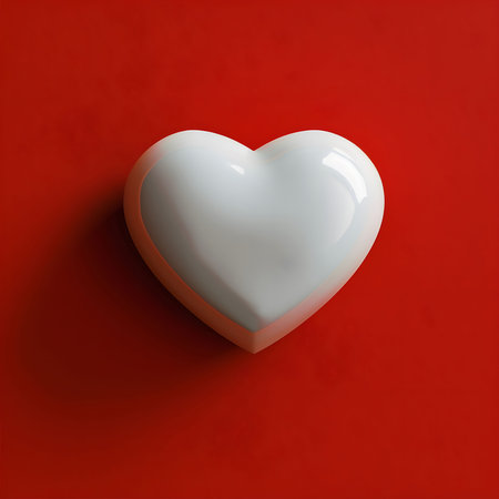 A pristine white heart rests on a vibrant red backdrop, a classic representation of love.の写真素材