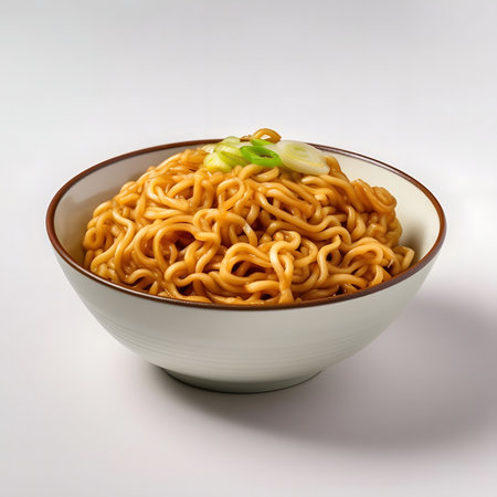 A close-up shot of a bowl of savory instant noodles topped with fresh green onions.の写真素材