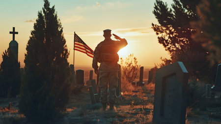 A soldier salutes during a sunset at a cemetery. The image evokes feelings of patriotism and remembrance.の写真素材