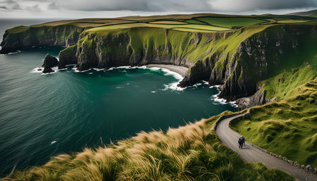 A scenic view of a winding road along a coastline with dramatic cliffs. The road leads towards the...