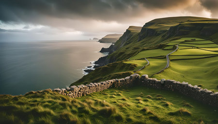 Stunning scenic view of the Irish coastline with dramatic cliffs, rolling hills, and a winding road. The image captures the beauty and ruggedness of the Irish landscape.の写真素材