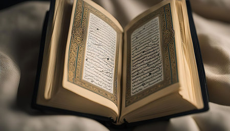 A close-up image of an open Quran book, showing the intricate Arabic calligraphy and the rich gold embellishments.の写真素材