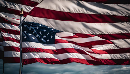 A vibrant American flag, with its red, white, and blue colors, proudly waves in the wind, showcasing its iconic stars and stripes.の写真素材
