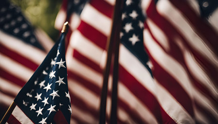 Close-up shot of a group of American flags waving in the wind, showcasing the red, white, and blue stripes with the stars in the canton.の写真素材