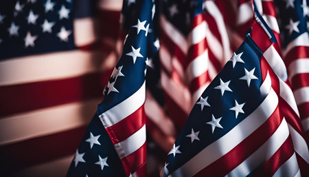 A close-up shot of multiple American flags, showcasing the iconic stars and stripes. The flags are waving gently, creating a sense of patriotism and national pride.の写真素材