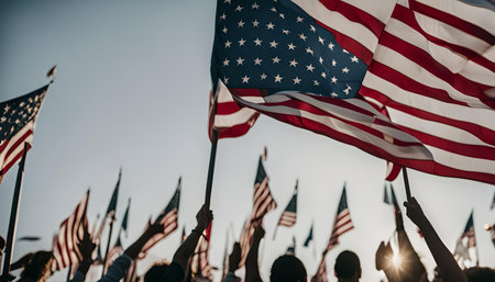 A group of people holding American flags up in the air, celebrating patriotism and national pride