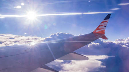 View from an airplane window on the right wing to see the sky in the evening.