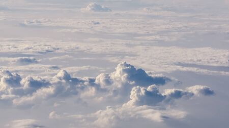 White cumulus clouds on clear blue sky background closeupの写真素材