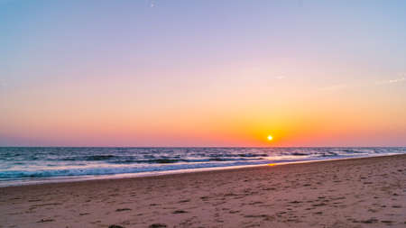 view from the beach on the setting sunの写真素材