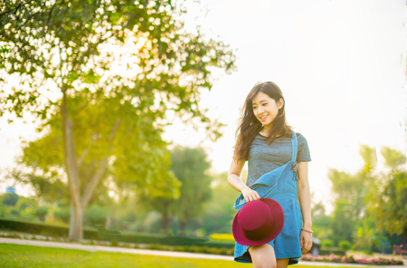 Portrait of happy woman relaxing in parkの写真素材