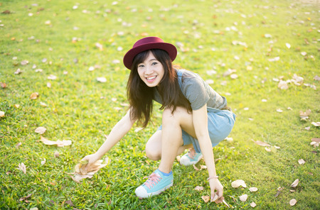 Woman relaxing in park enjoying her freedom wear short dress,Woman smiling happy freedom with sunlightの写真素材