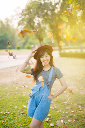 Woman relaxing in park enjoying her freedom wear short dress,Woman smiling happy freedom with sunlightの写真素材
