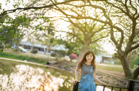 Portrait of happy woman relaxing in parkの写真素材