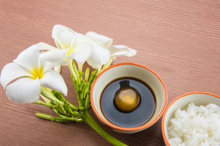 Raw Egg in soy sauce and Plumeria flower,Tamago kake gohanの写真素材