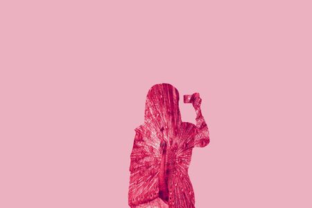 Double exposure of young woman holding cameraの写真素材