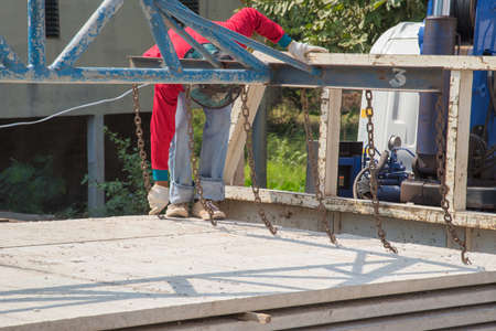 Worker placing cement floor in construction siteの写真素材