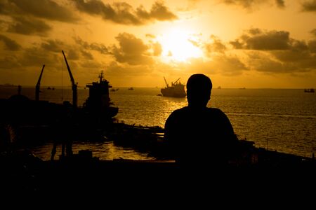 Silhouette man standing on a port in Male,Maldivesの写真素材