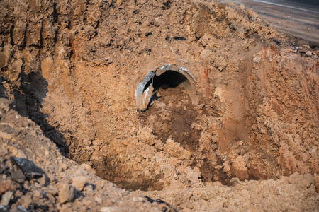 Old sewage water from sewer waiting for maintenance During the construction of a new road.の写真素材