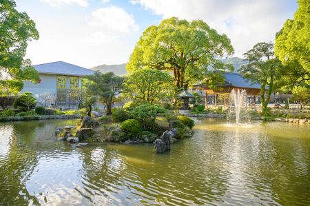 Green garden park with pond at Dazaifu Tenmangu Shrine,one of the most well-known Shinto shrines in Japan.のeditorial素材