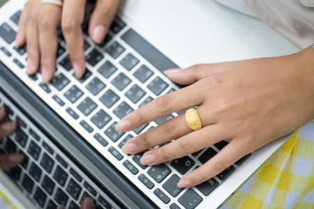 Person Typing on a modern laptop on parkの写真素材