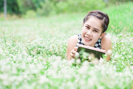 Beautiful Young Woman With Tablet Computer In Park の写真素材