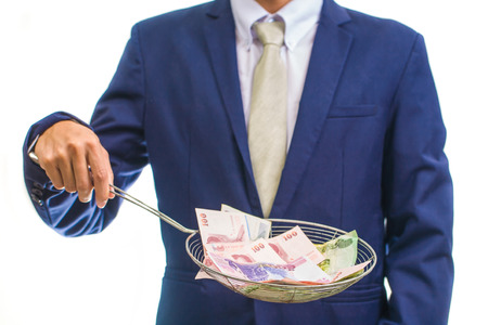 Portrait of a business man holding money, isolated on whiteの写真素材