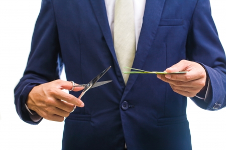 Business Man cutting money の写真素材