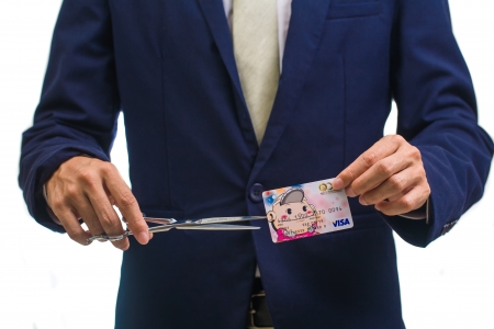 Man cutting money の写真素材