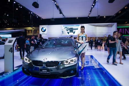 NONTHABURI - DECEMBER 8: Unidentified many modelling posted with BMW 420d Coupe Sport display at The 30th Thailand International Motor Expo on December 8, 2013 in Nonthaburi, Thailand.のeditorial素材