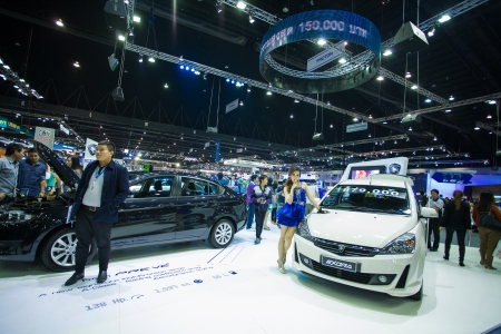 NONTHABURI - DECEMBER 8: Unidentified modellings posted over Proton exora display on stage at The 30th Thailand International Motor Expo on December 8, 2013 in Nonthaburi, Thailand.のeditorial素材