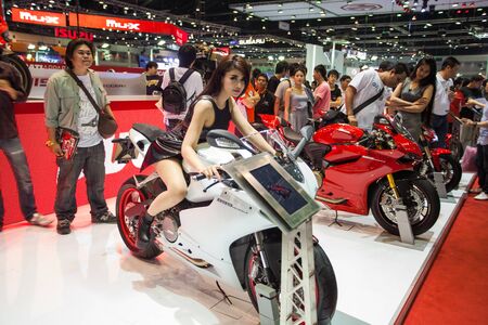 NONTHABURI - DECEMBER 8: Unidentified modellings posted over Ducati 899 motorcycle display on stage at The 30th Thailand International Motor Expo on December 8, 2013 in Nonthaburi, Thailand.のeditorial素材