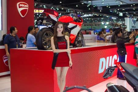 NONTHABURI - DECEMBER 8: Unidentified modellings posted over Ducati 1199 motorcycle display on stage at The 30th Thailand International Motor Expo on December 8, 2013 in Nonthaburi, Thailand.のeditorial素材