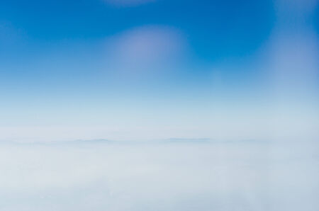 Blue sky with clouds, shot from an airplane. The upper layers of the atmosphere.の写真素材