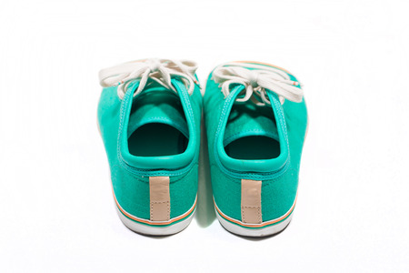 Pair of new green sneakers isolated on whiteの写真素材