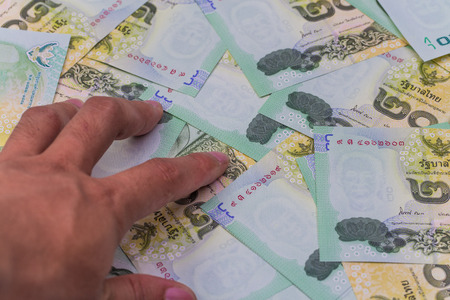 close up of thai money with handの写真素材