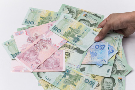 Thai bath close up of money with hand that use in Thailandの写真素材