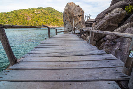 boardwalk on the split rock to the beach, blue skyの写真素材