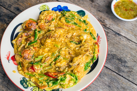 Fried crab with curry powder on wood tableの写真素材