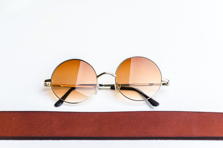 Fashion of vintage glasses and brown belt isolated on whiteの写真素材