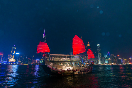 HONG KONG - Dec 7: Victoria Harbor on December 7, 2014 in Hong Kong. An old chinese junk departed from Ocean Terminal and drove across Victoria Harbor.のeditorial素材