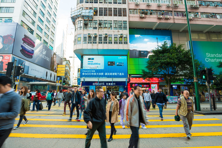 HONG KONG, CHINA - Dec 8: Crowded street view on December 8, 2014 in Hong Kong, China. With 7M population and land mass of 1104 sq km, it is one of the most dense areas in the world.のeditorial素材
