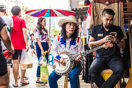 BANGKOK , Thailand - JAN 25 : Thai street musicians perform in Chatuchak market on January 25, 2015...