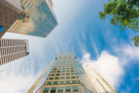 Modern glass city buildings during sunny day. Low angle shotの写真素材