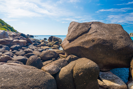Rock beach and blue sky with beautiful clouds tropical sea,  Rocks at natural bayの写真素材