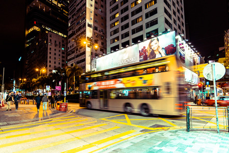 HONG KONG, CHINA - DECEMBER 4: Street view with traffic and shops at night on December 4, 2014 in Hong Kong, China. With 7M population and land mass of 1104 sq km, it is one of the most dense areas in the world.のeditorial素材