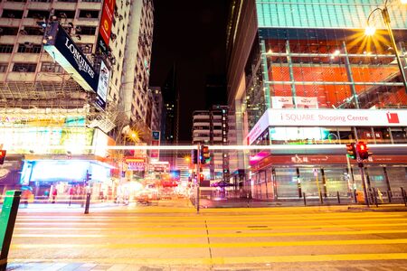 HONG KONG, CHINA - DECEMBER 4: Street view with traffic and shops at night on December 4, 2014 in Hong Kong, China. With 7M population and land mass of 1104 sq km, it is one of the most dense areas in the world.のeditorial素材