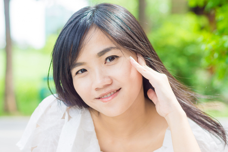 Young asian woman relaxing in the park, Close upの写真素材
