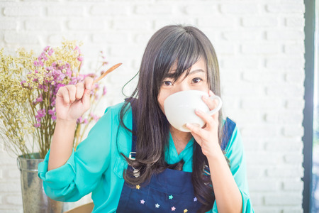 Happy asian young woman drinking coffee, Business woman Having a Coffee Break.の写真素材