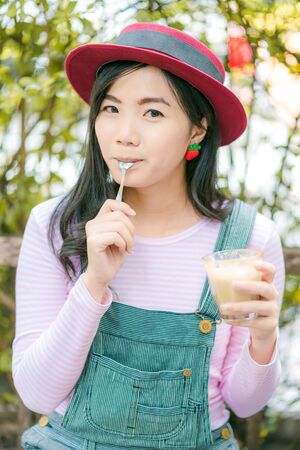 Beautiful cute girl in the cafe hold coffee mug, Happy young woman drinking coffeeの写真素材