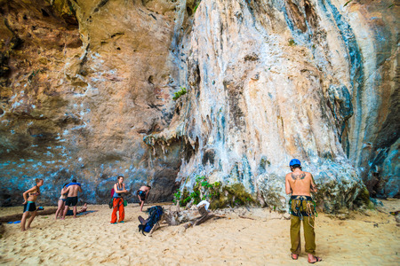 RAILAY, THAILAND - JULY 20, 2015: Rock climbers and tourists on Railay beach, one of the most popular rock climbing locations in Asia.のeditorial素材